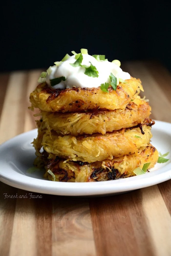 spaghetti squash, low carb breakfast ideas, stacked together, sour cream, parsley on top, white plate
