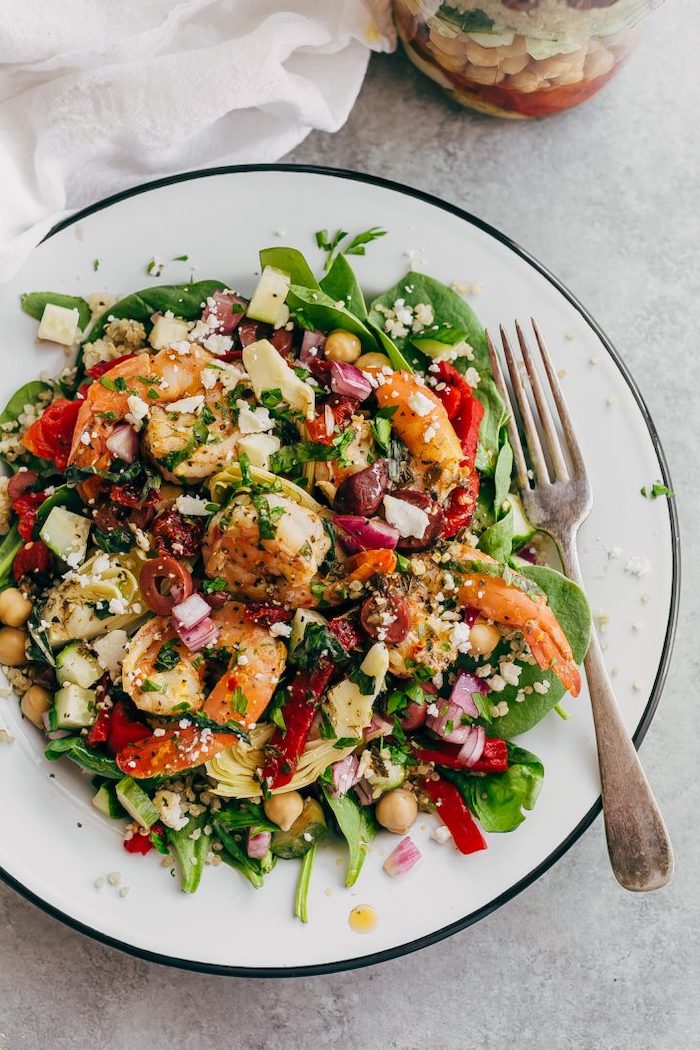 chickpeas and spinach, greek quinoa salad, meal prep for weight loss, in a white plate, silver fork