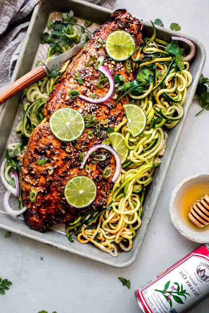 baked salmon, sriracha glazed, lime sliced on top, zoodles on the side, making zucchini noodles