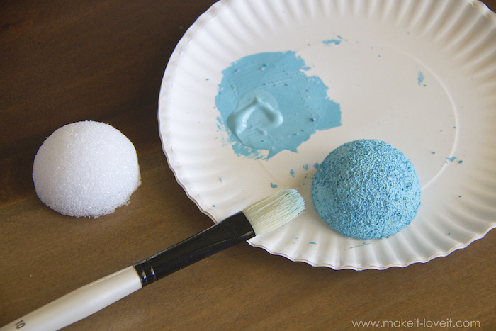 baby costumes for boys, styrofoam ball, cut in half, painted in blue, white paper plate, wooden table