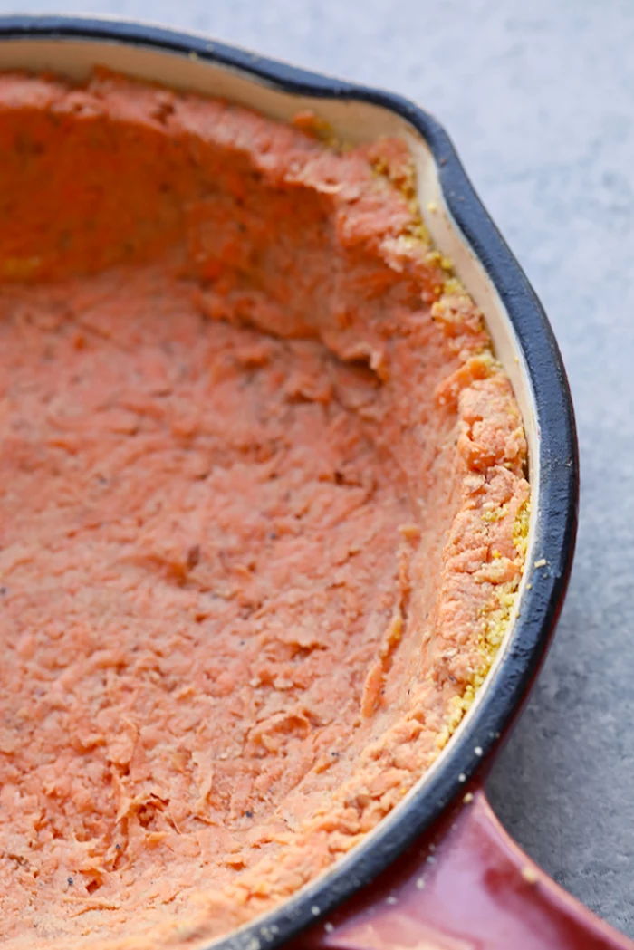 sweet potato crust, at the bottom, of a red skillet, granite countertop, meal prep recipes