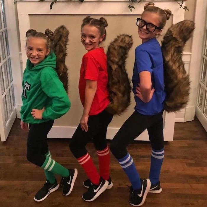 three girls, dressed as characters, from alvin and the chipmunks, twin halloween costumes, green red blue shirts