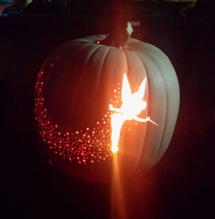 tinkerbell carved into a pumpkin, pixie dust, peter pan inspired, pumpkin carving patterns, lit by candles