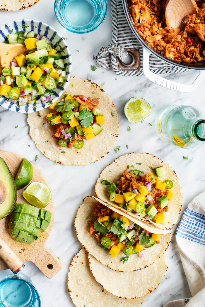 tortilla wraps, filled with vegetables, best taco seasoning, avocado slices, lime slices, marble countertop