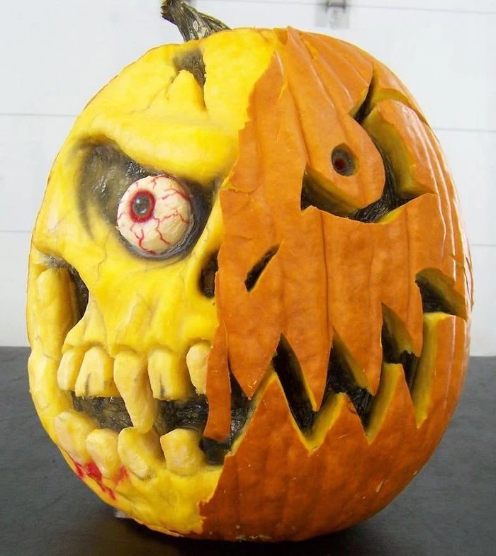 two faced pumpkin, one side without skin, scary face, carved into it, easy pumpkin carving ideas, white background