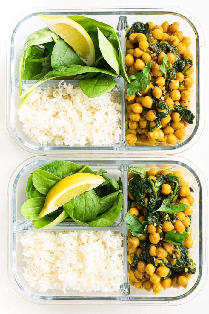 rice and spinach, meal prep for weight loss, chickpeas with parsley, lemon slice, in a glass container