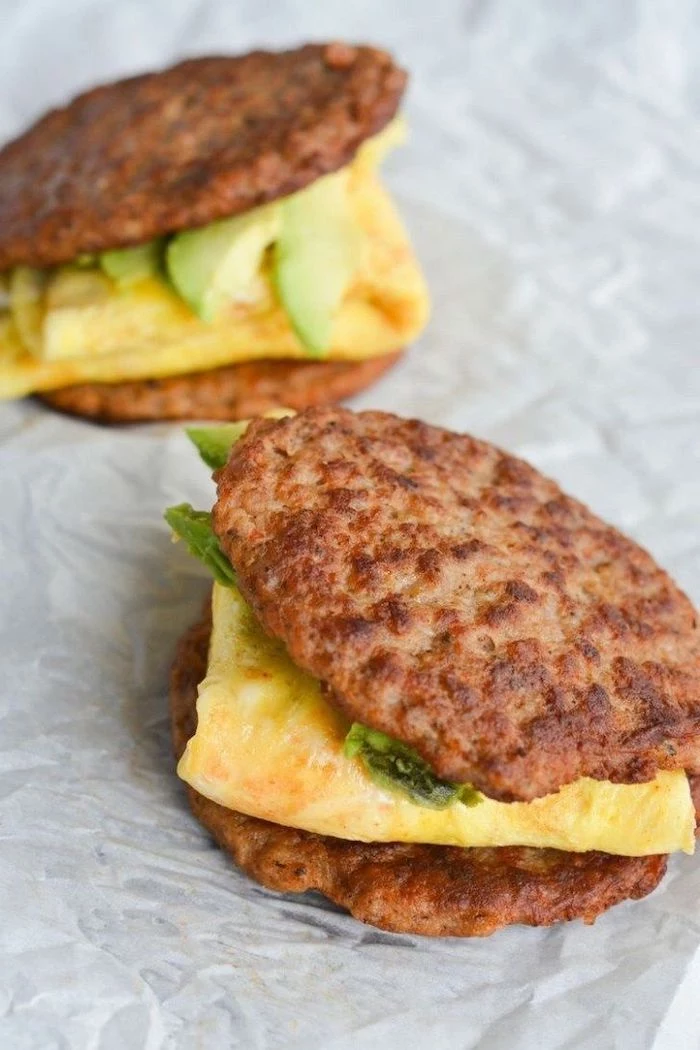low carb breakfast ideas, ground beef sandwich, ham and cheese omelet inside, guacamole sauce