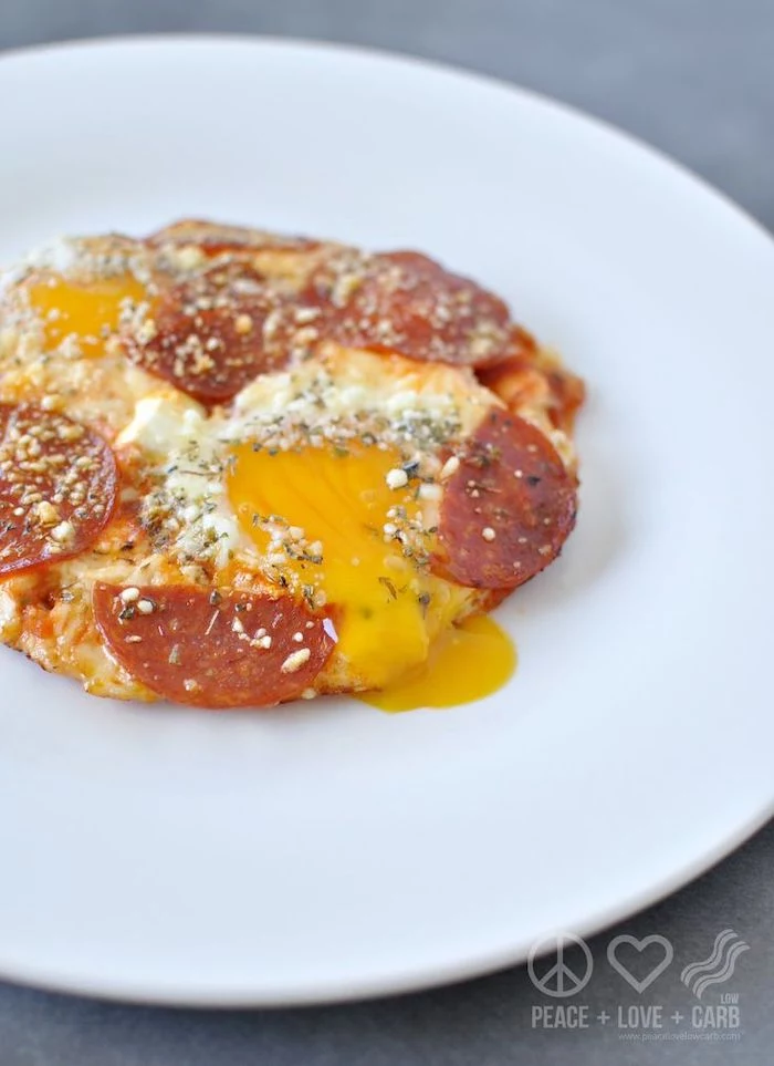granite countertop, white plate, keto diet breakfast, egg pizza, with pepperoni slices