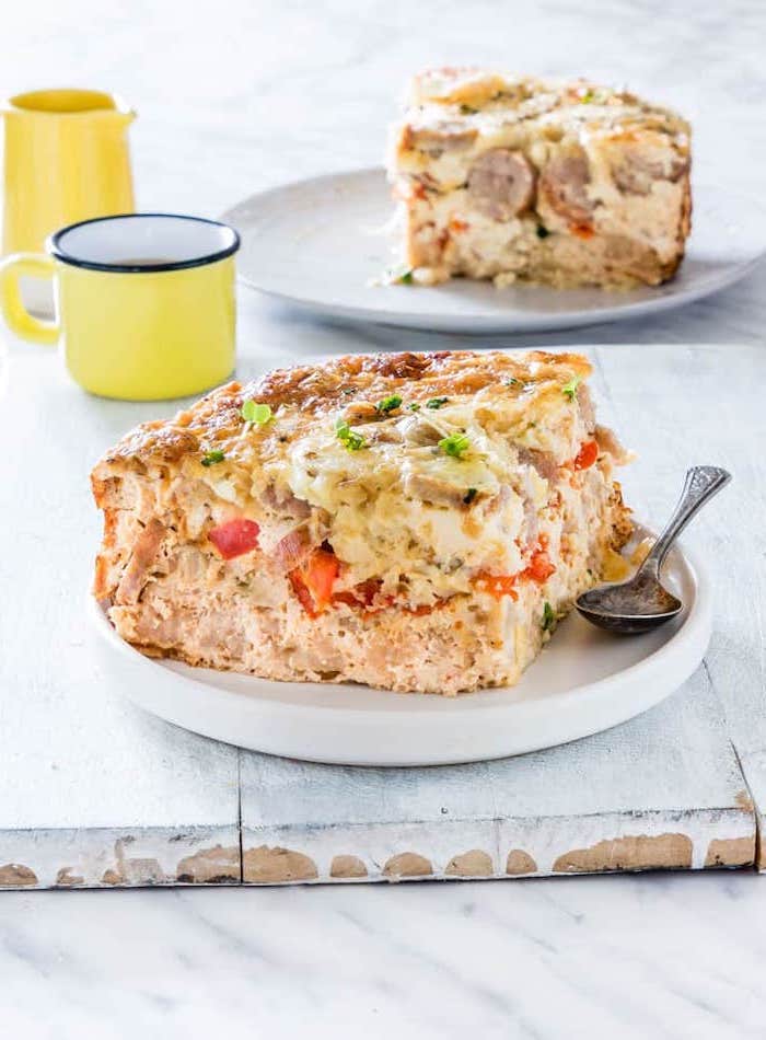 breakfast casserole, with sausage and tomatoes, chives on top, white plate, low carb breakfast without eggs, yellow mug