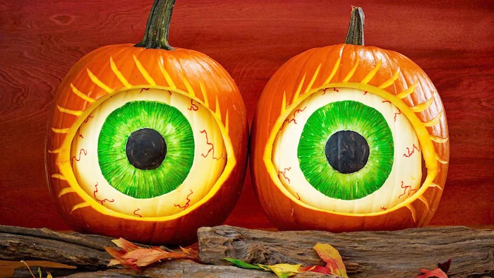 white pumpkins, eyes drawn on them, inside larger pumpkins, how to carve a pumpkin, wooden logs