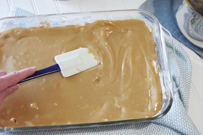 quick easy desserts, caramel spread in a glass tray, white spatula, white wooden table