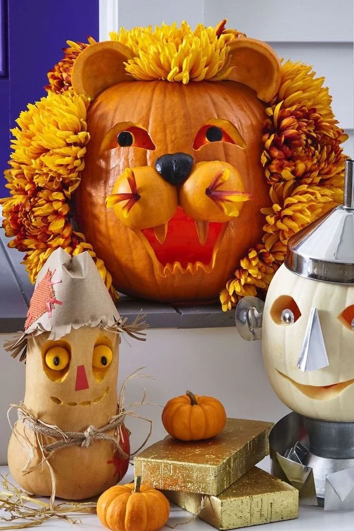 wizard of oz characters, carved into pumpkins, halloween pumpkin carvings, arranged on a patio