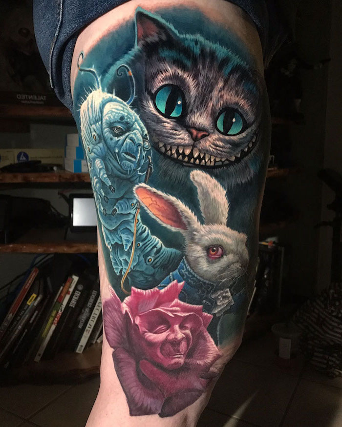 thigh tattoos for women, alice in wonderland inspired, cheshire cat, colored tattoo