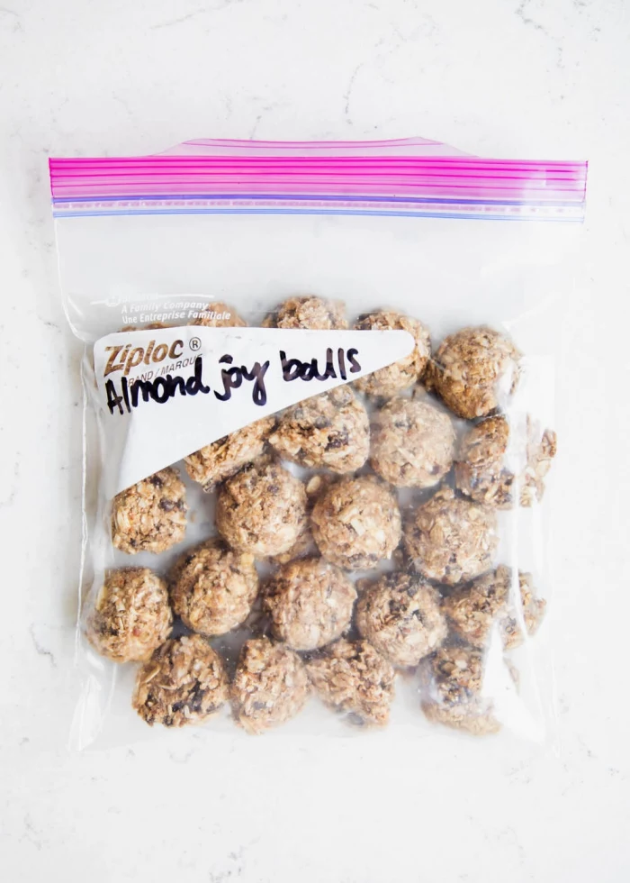 almond joy balls, peanut butter energy balls, in a ziploc bag, marble countertop