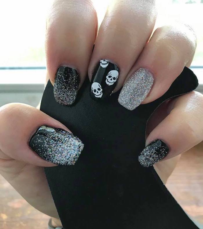 silver glitter, black nail polish, popular nail colors, white skulls, nail decorations, squoval nails