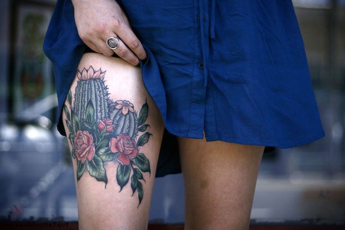 blue dress, cactuses and flowers, red roses, blurred background, thigh tattoos for women