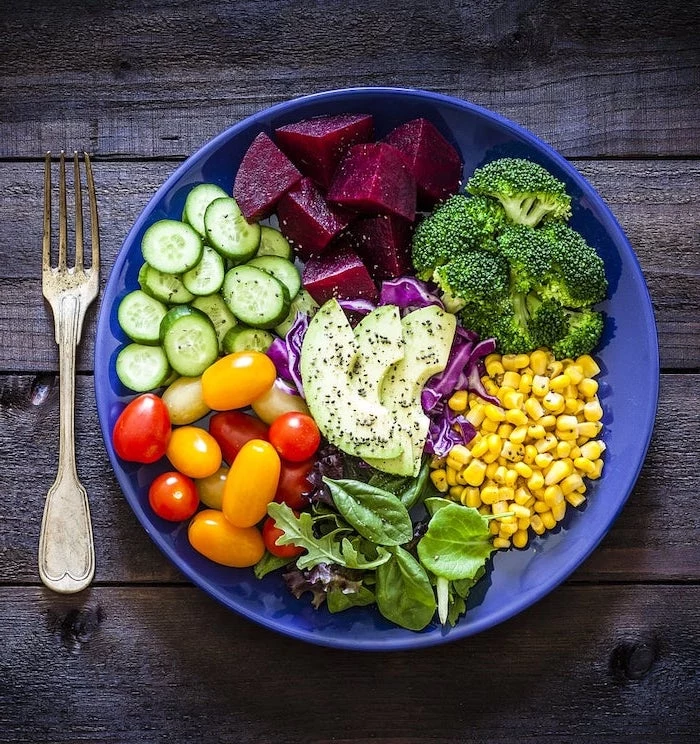 blue bowl, filled with vegetables, healthy meal plans, beets and broccoli, corn and spinach, avocado and tomatoes
