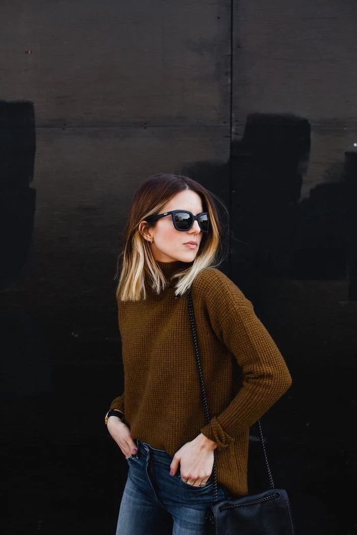 woman with balayage blonde hair, wearing brown sweater and jeans, sunglasses and bag, medium length hairstyles for women