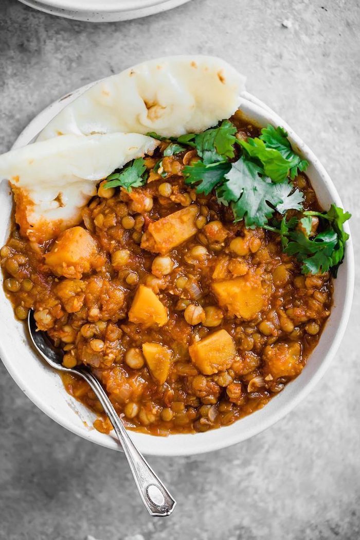 butternut squash, lentil stew, healthy recipes for weight loss, pita on the side, parsley garnish, white bowl