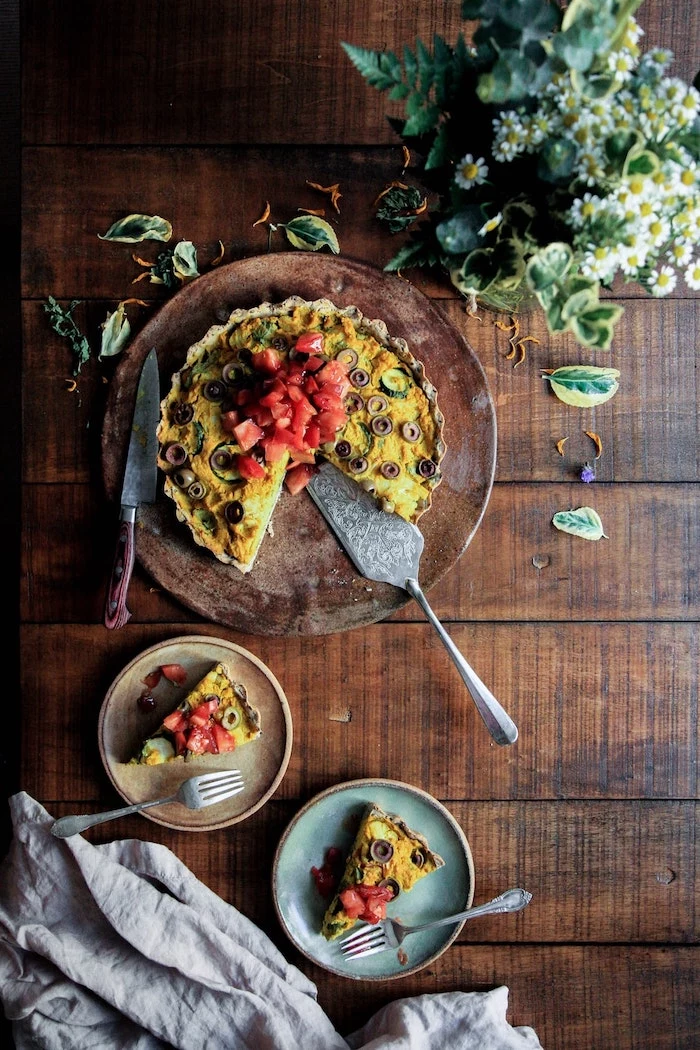 egg quiche, with olives and tomatoes, meal prep for weight loss, wooden cutting board, wooden table
