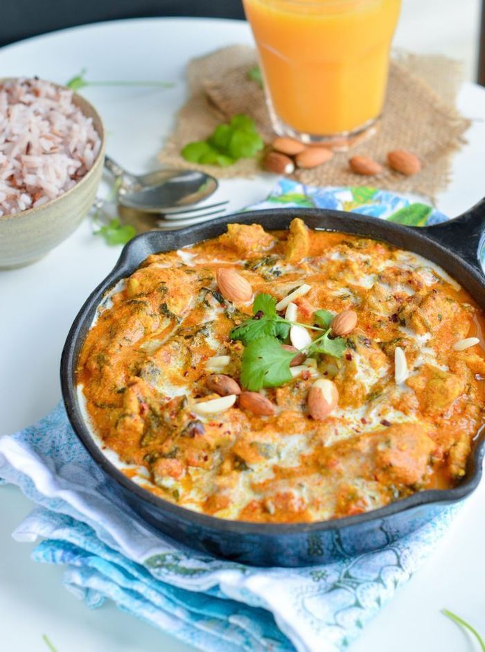 chicken tikka masala, black skillet, orange juice, best weight loss diet, blue cloth, almond and parsley garnish