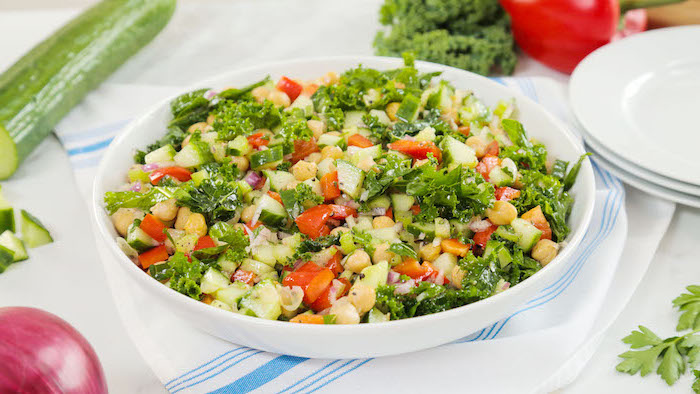 chickpea salad, healthy meal prep ideas, cucumbers and tomatoes, onion and parsley, in white plate