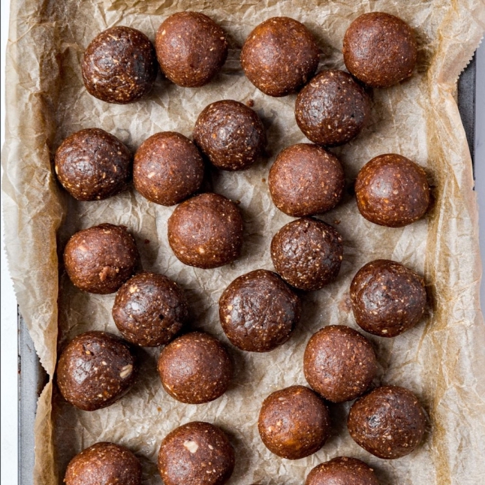 chocolate truffles, no bake protein balls, arranged on baking paper, in a tray