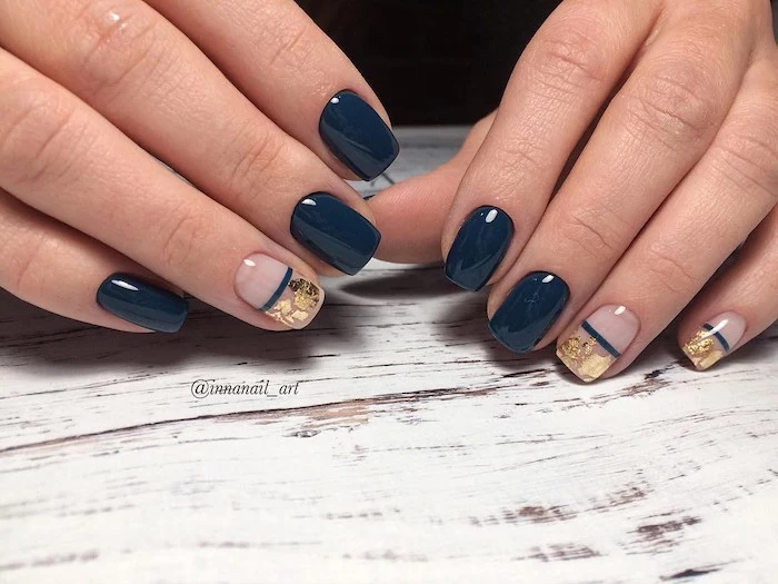 dark blue nail polish, gold glitter, nail decorations, nail color ideas, wooden table, short squoval nails