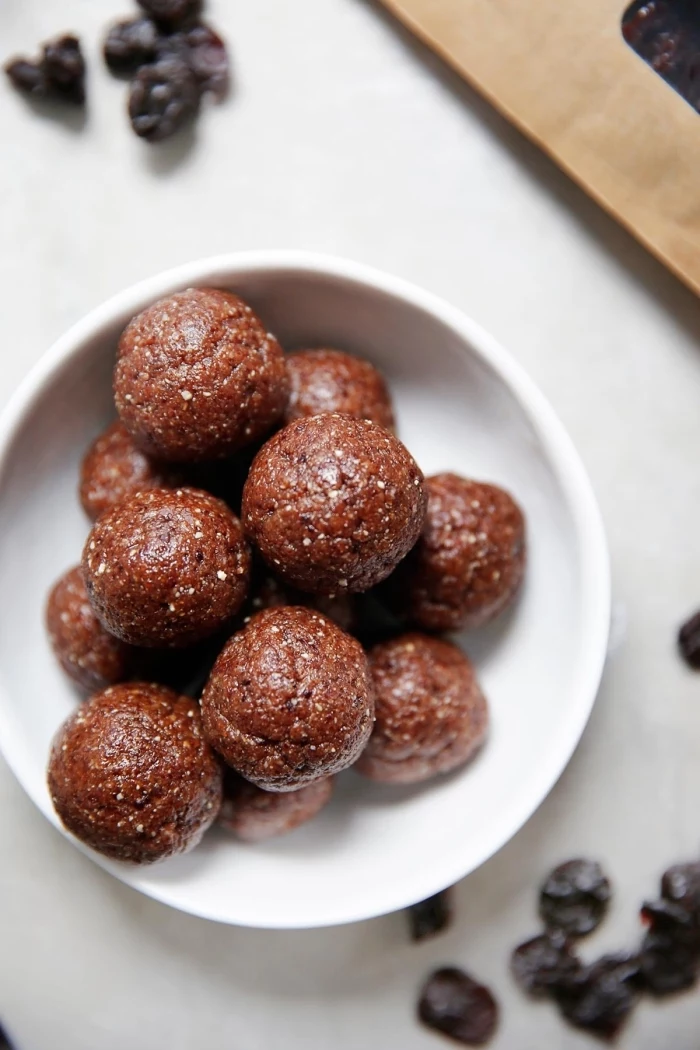 dates scattered on the table, chocolate truffles, in a white bowl, peanut butter energy balls