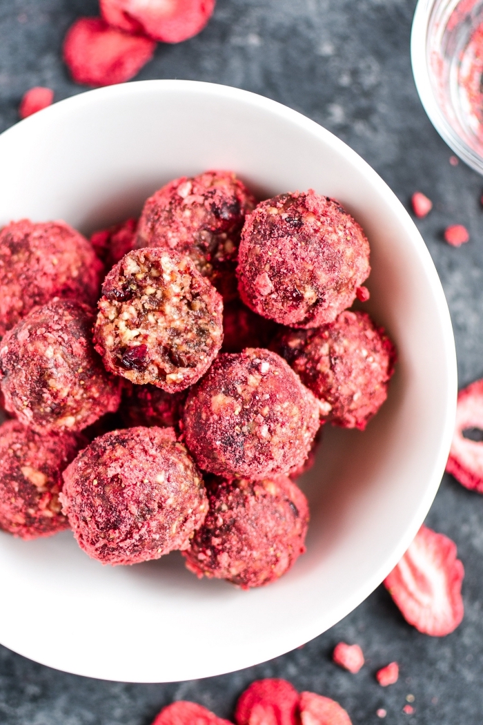 dried strawberries, made into powder, no bake energy balls, covered with powder, in white bowl