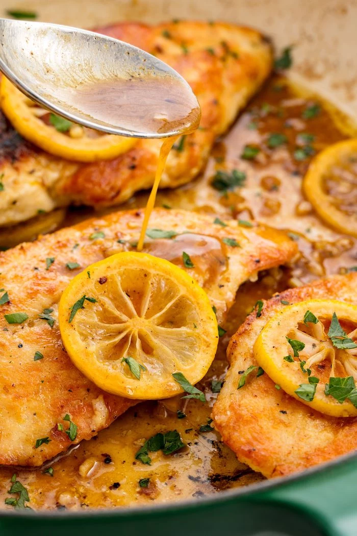 lemon pepper chicken, sauce poured on top, lemon slices on top, what to cook for dinner tonight easy, parsley for garnish