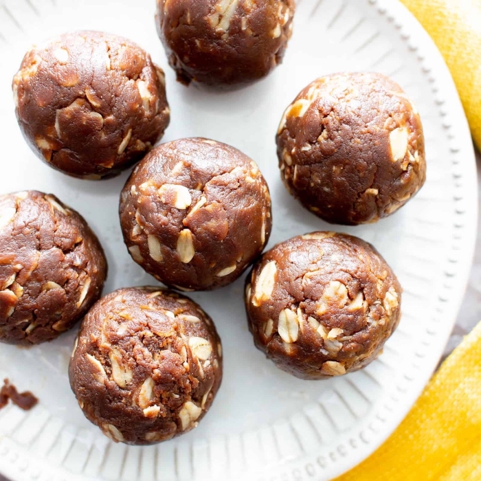 yellow cloth, white plate, no bake energy balls, with peanuts and oatmeal
