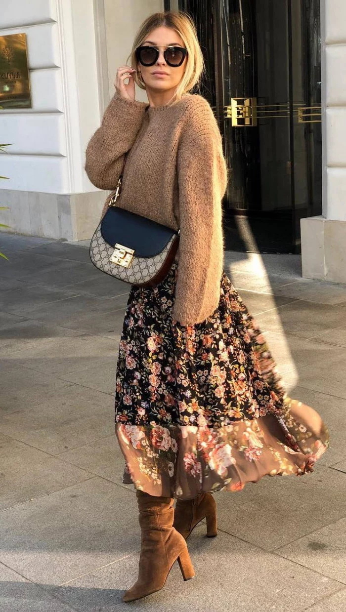 woman wearing sunglasses, brown sweater and floral skirt, brown velvet boots, medium length layered hair, crossbody bag
