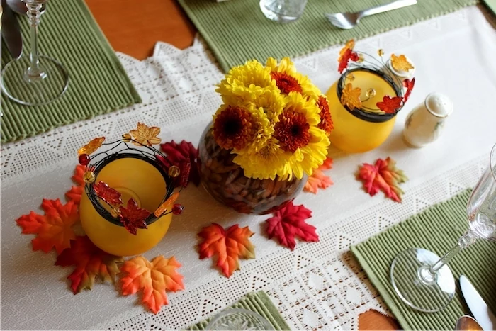 outdoor thanksgiving decorations, yellow and orange, flower bouquet, fall leaves, wine glasses white table runner