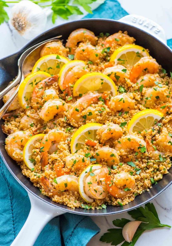 diet plans for women, garlic quinoa shrimp, with lemon sauce, lemon slices, in a skillet, blue cloth