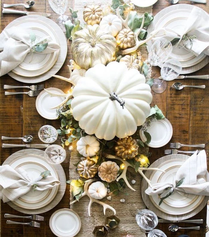 big white pumpkin, smaller pumpkins, painted gold, arranged as table runner, outdoor thanksgiving decorations, wooden table