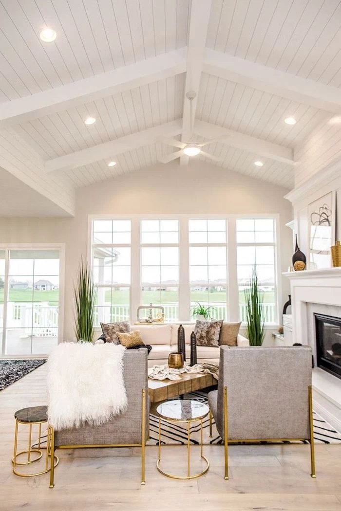 white aesthetic, grey armchairs, brass side tables, vaulted ceiling ideas, tall windows, wooden floor