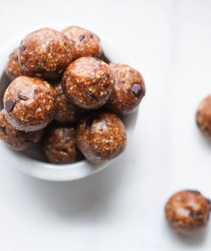 white table, peanut butter bites, with chocolate chips, power balls recipe, in white bowl