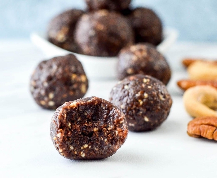 white table, chocolate truffles, with nuts, power balls recipe, blurred background