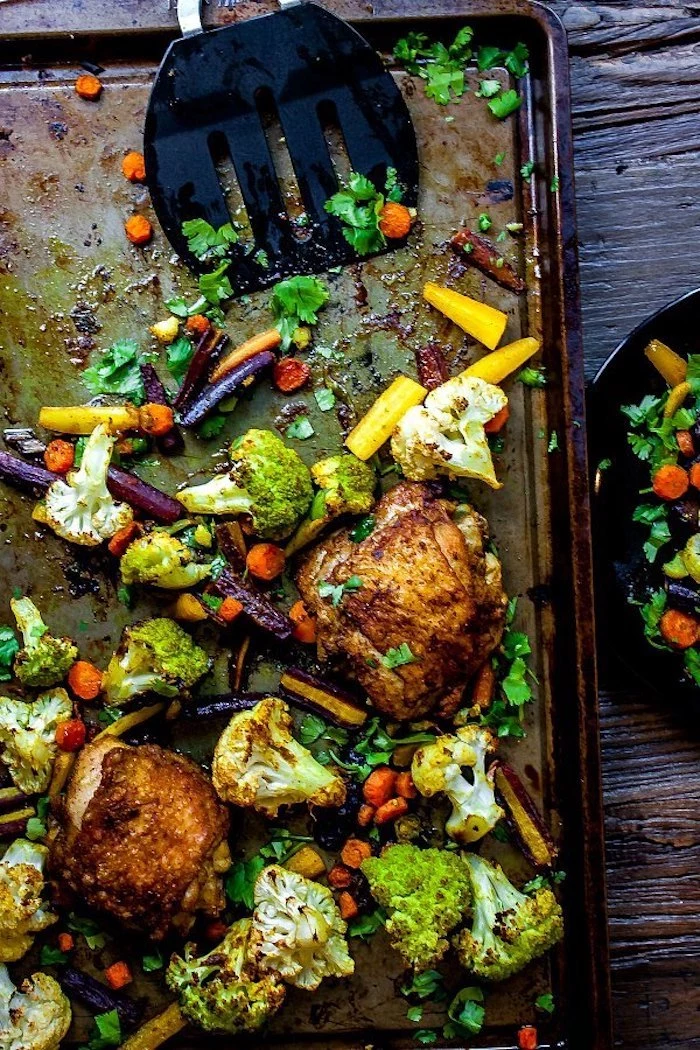 chicken with vegetables, cauliflower and broccoli, carrots and cabbage, sheet pan, wooden table, weight loss meal plan