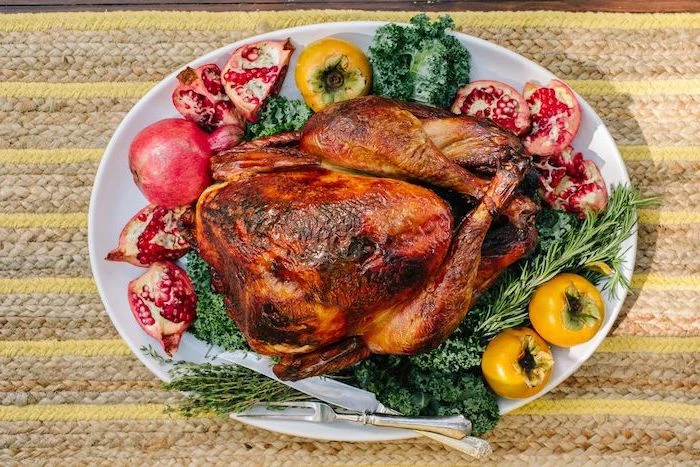 roasted turkey, how to cook a turkey in the oven, pomegranates and apples, fresh herbs, on the side