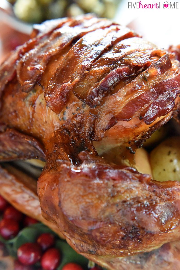 roasted turkey, covered in bacon, stuffed with onion, cranberries and fresh herbs, how to cook a turkey