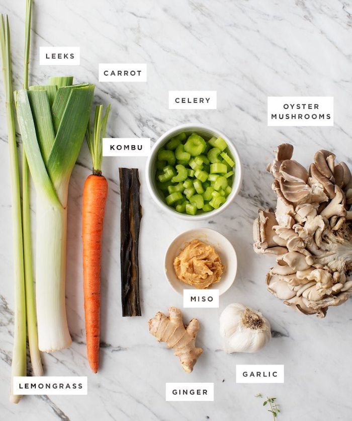 leeks and lemongrass, carrot and kombu, celery and miso, ginger and garlic, oyster mushrooms, healthy dinner ideas, on marble table