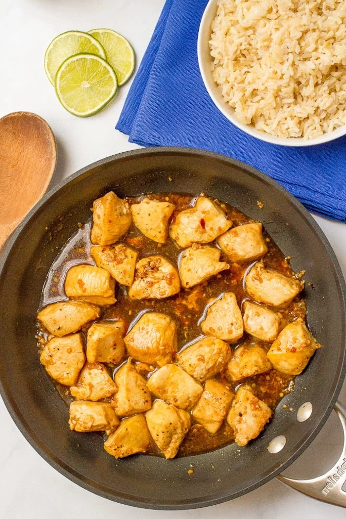rice in white plate, on blue cloth, easy weeknight dinners, honey garlic chicken, cooked in skillet, lime slices