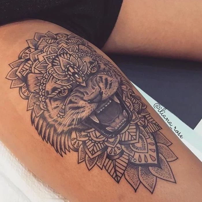 mandala tattoo, lion roaring, leg tattoo ideas, black shorts, white paper napkins