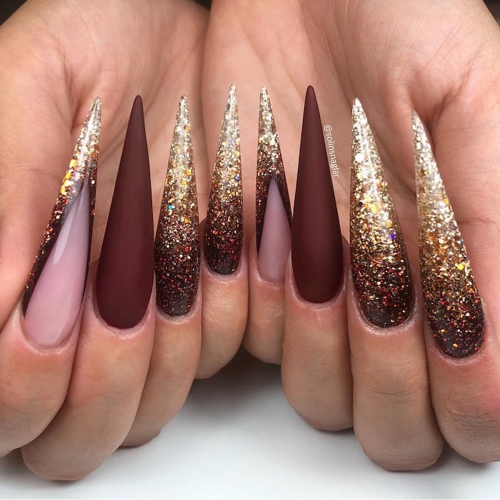 red burgundy, matte nail polish, gold glitter, long stiletto nails, white background, fall nail ideas