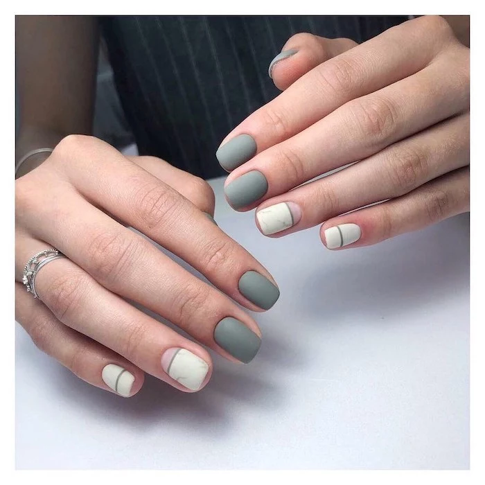 neutral nail colors, grey and white, matte nail polish, short squoval nails, white table, silver rings