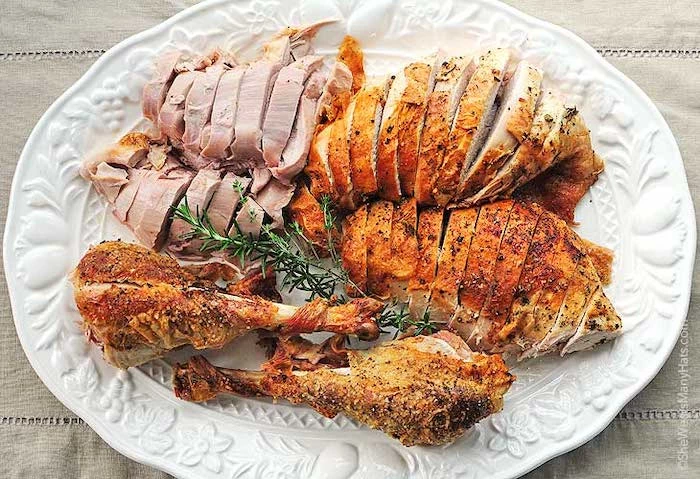 carved turkey, in a white plate, fresh rosemary, on the side, what temperature to cook a turkey