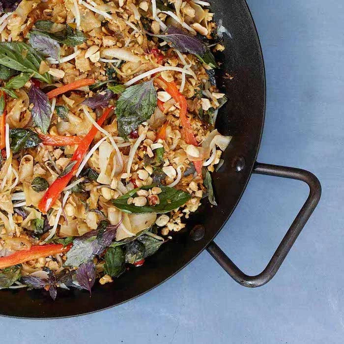stir fry, in a black skillet, foods that help you lose weight, pasta with basil, nuts and peppers, basil leaves