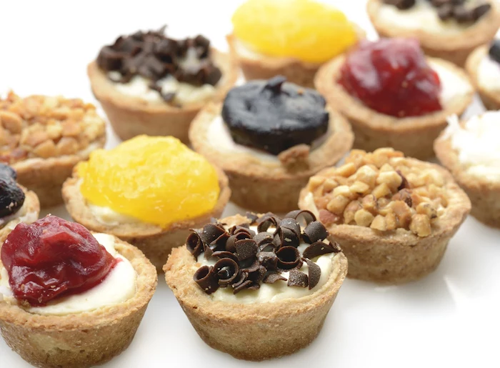 mini cheesecakes, thanksgiving cake ideas, chocolate shavings, cranberry jam, crushed peanuts, on top